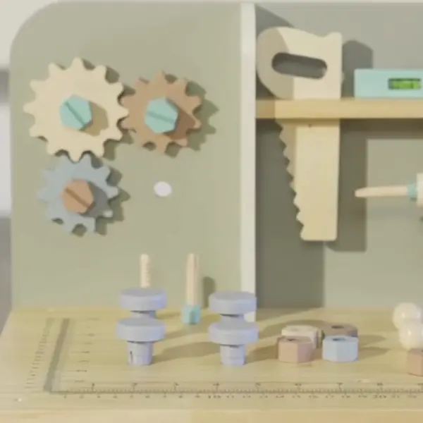 child playing with a pretend wooden tool bench with tools