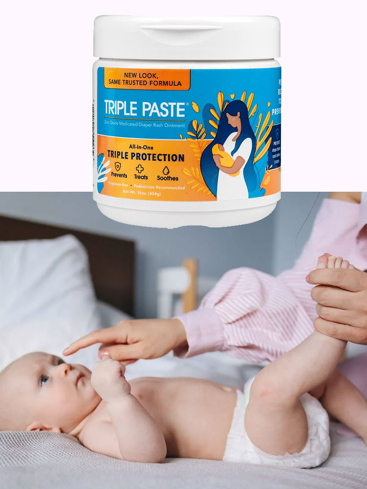 mom playing with baby during a diaper change alongside a jar of triple paste diaper rash ointment