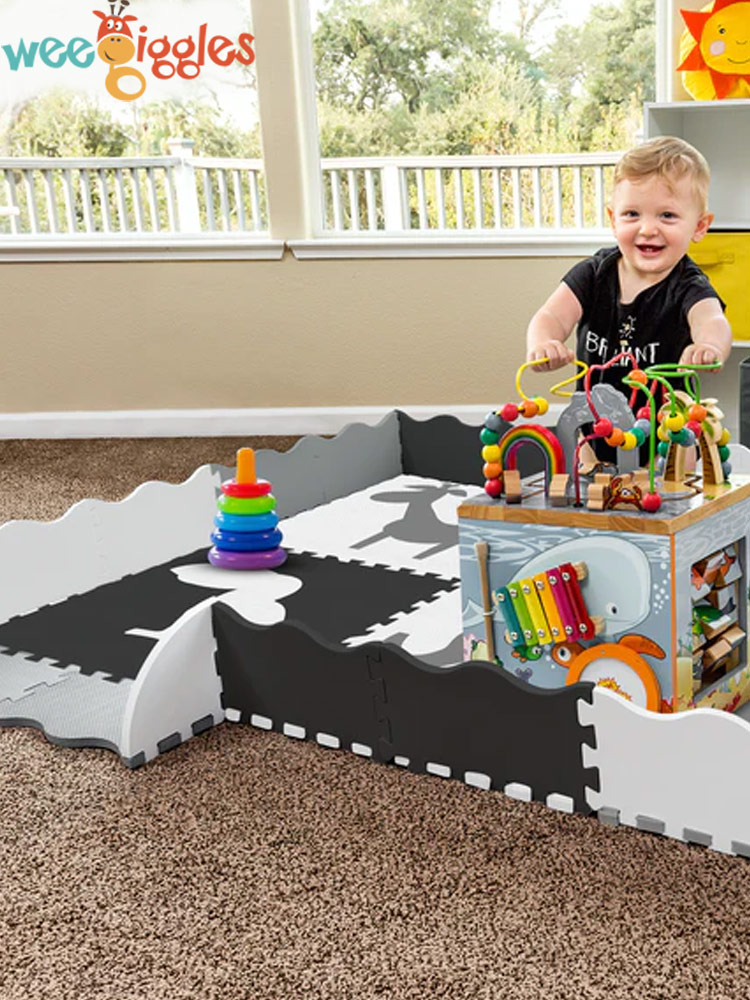 toddler boy playing with toys on a wee giggles playmat