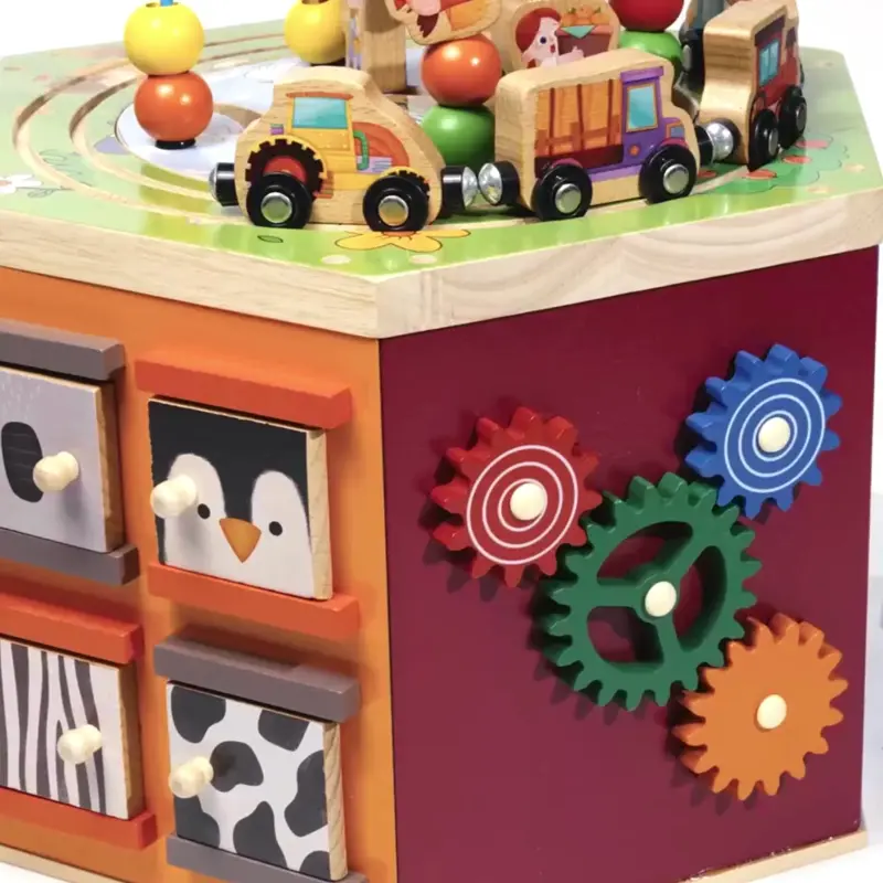 demonstrating the wooden activity cube for babies